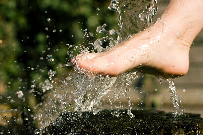 Splash of cold water showered on feet